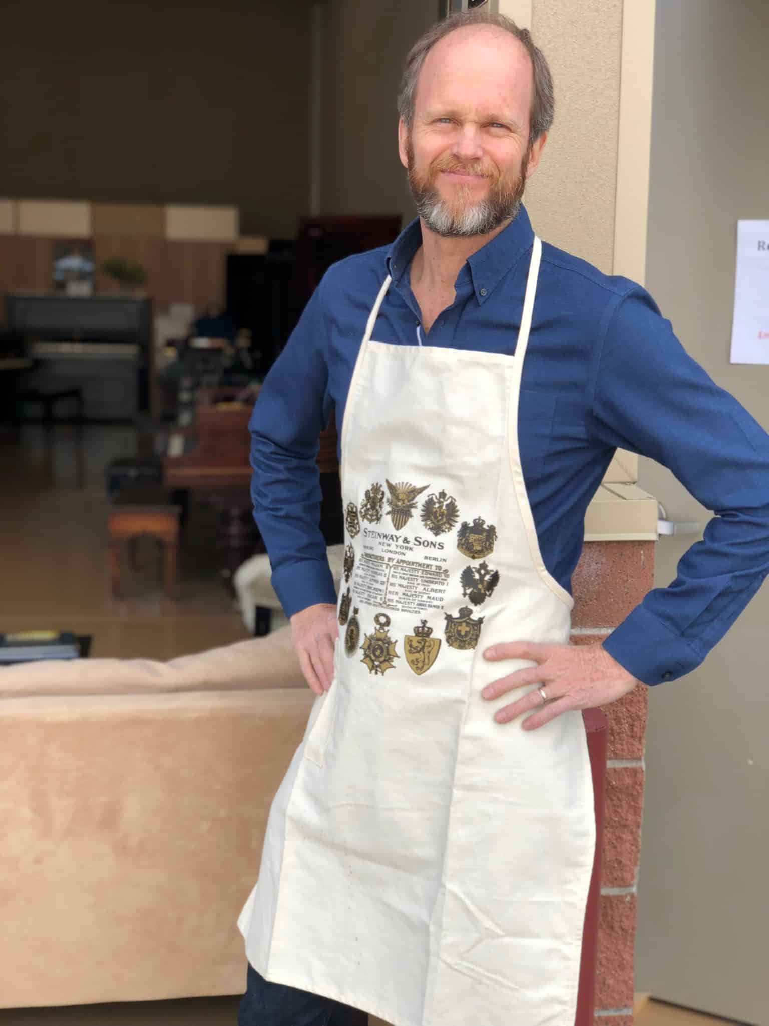 Renaissance Piano Service technician wearing a Steinway apron in the workshop