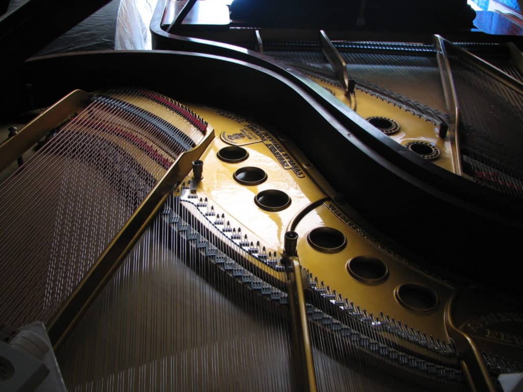 Two grand pianos nested closely together for climate-controlled storage